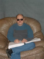 Keith Reedy, Bibles for the Blind Director, Sitting Reading Braille Bible